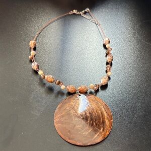 Elegant Brown Beaded Necklace With Shell Pendant
